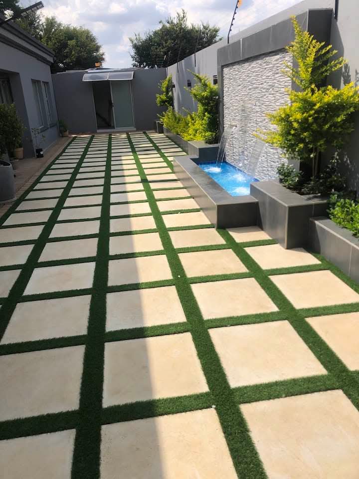 Modern courtyard with water feature and grid stone walkway