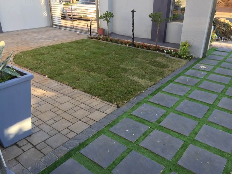 Courtyard with slate paver grid, brick paving and central lawn