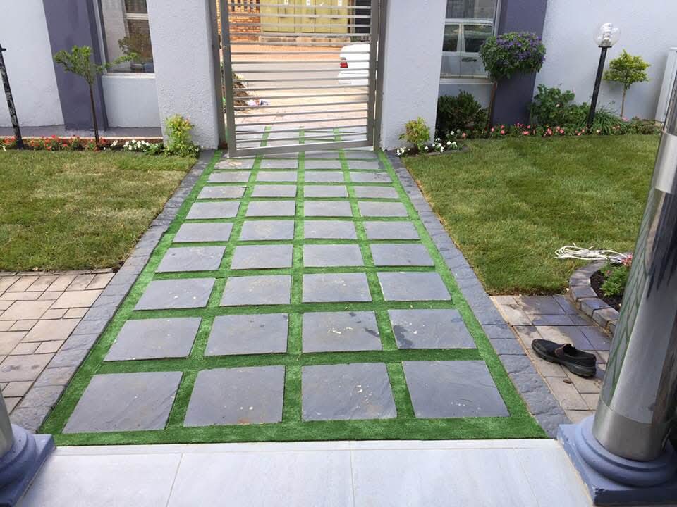 Slate and turf grid walkway leading to property gate