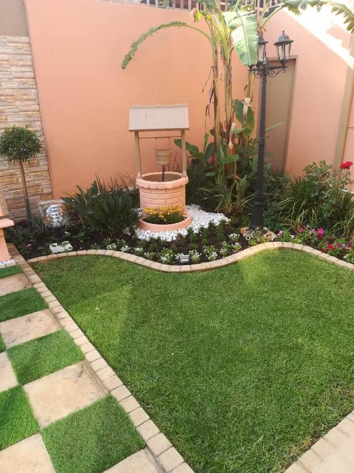 Landscaped garden bed with curved brick border and mixed planting