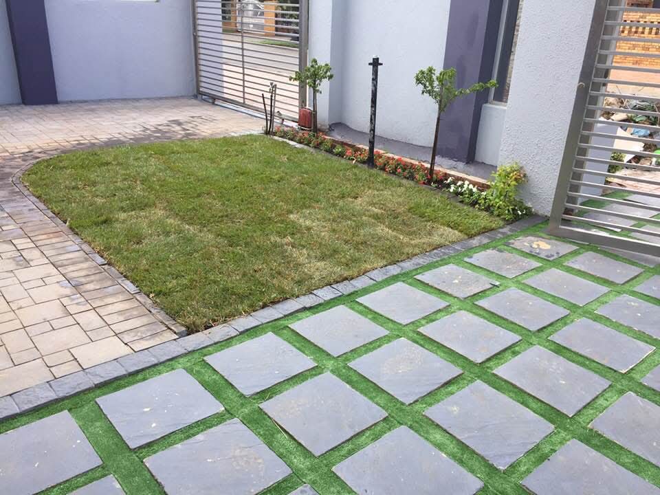 Courtyard with slate grid pavers, brick paving and central lawn