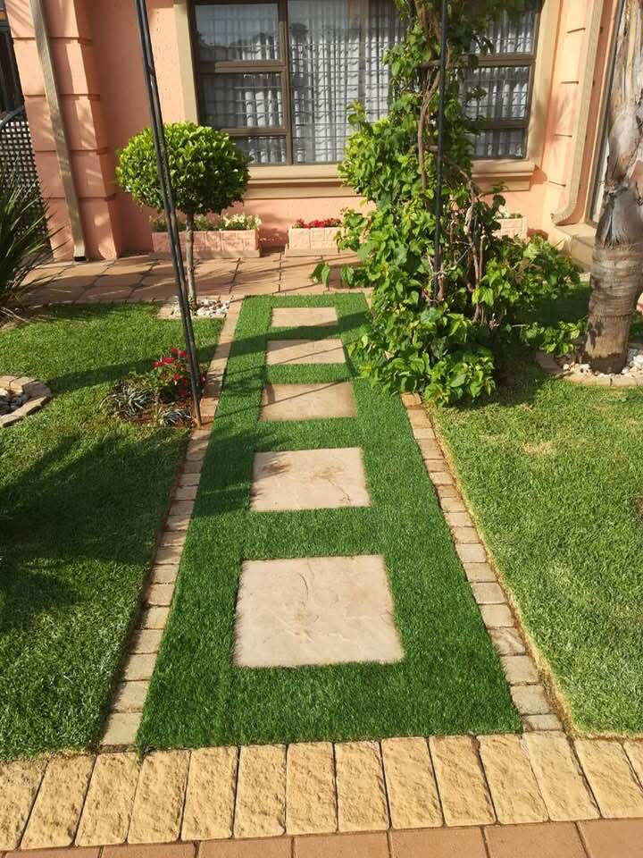 Front yard stepping stone path with brick borders and topiary